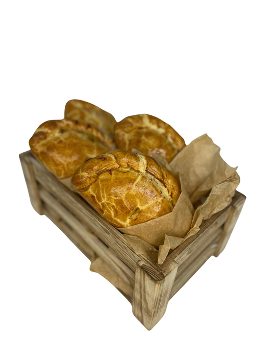 Golden handmade Ansum pasties in a wooden crate