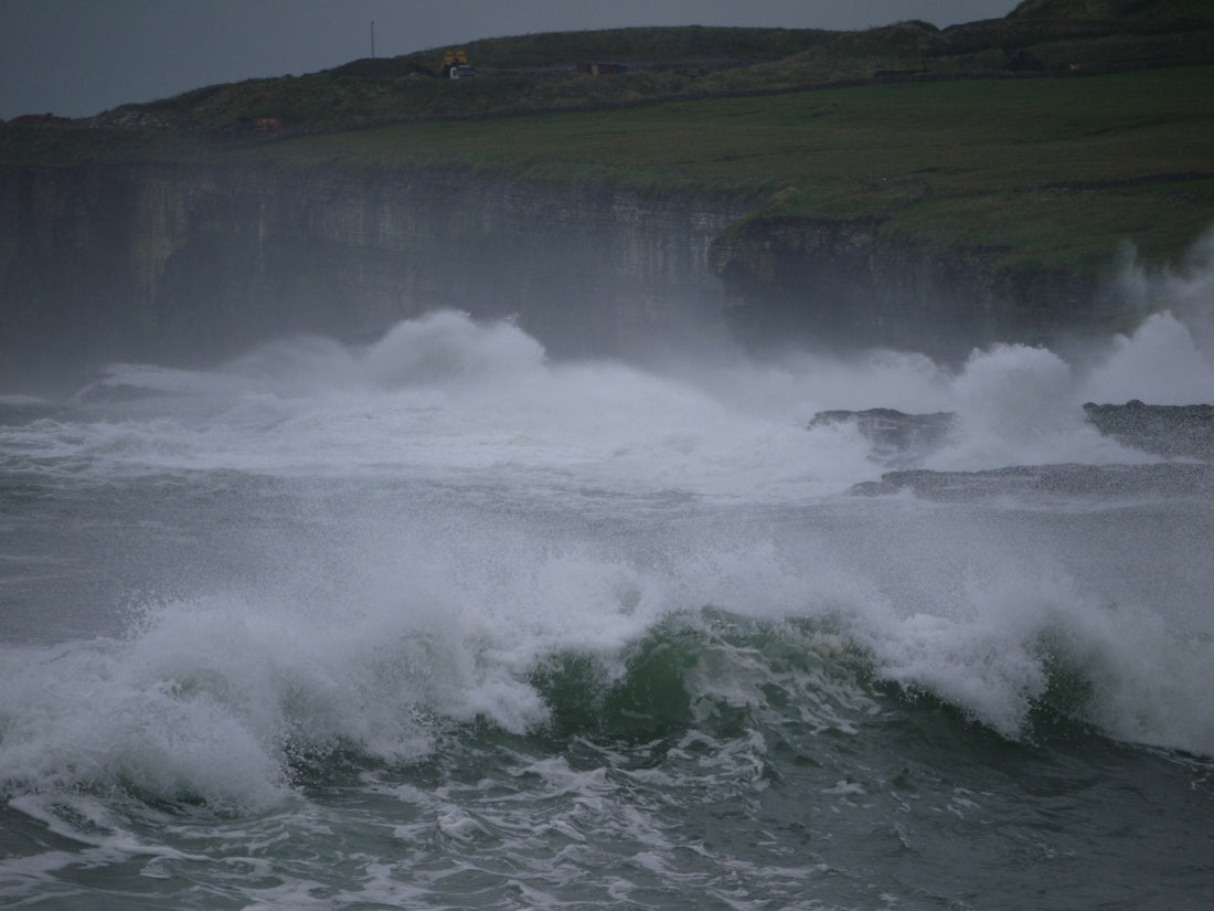 Stormy ocean waves crashing against a rocky coastline