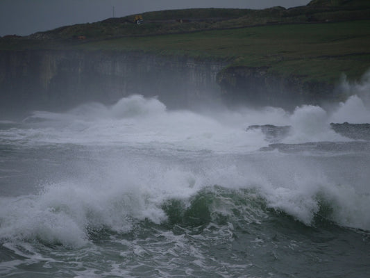 Stormy ocean waves crashing against a rocky coastline