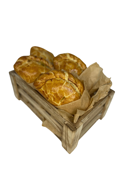 Golden baked Ansum pasties in a wooden crate